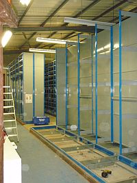 Old archive roller shelving being dismantled before being rebuilt at Cranfield